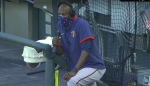 Minnesota Twins coach LaTroy Hawkins giving interview while wearing face mask